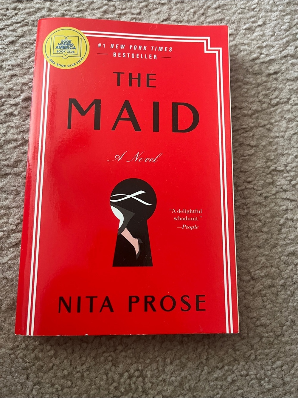 The Maid by Nita Prose - Red Paperback Novel